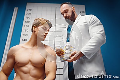 The doctor demonstrates the departments of the spine vertebrae, hernia and its injuries in the medical office Stock Photo