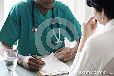 Doctor diagnose patient symptoms at the hospital Stock Photo