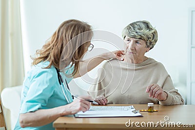 Doctor diagnosing elder woman Stock Photo