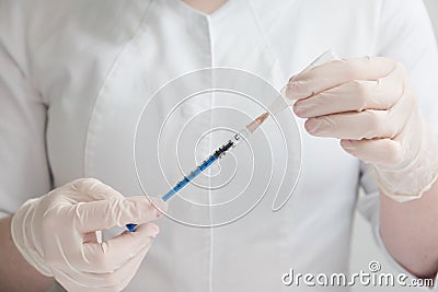 The doctor dials the liquid into the syringe. Concept of care and prevention. Vaccination. Insulin syringe, diabetes Stock Photo