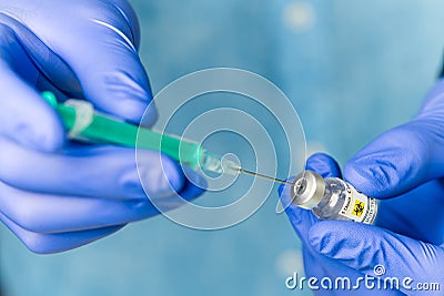 doctor dials the vaccine into a syringe. a nurse with a vaccine and a syringe in her hands Stock Photo