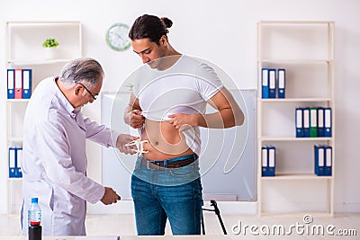 Doctor dietician giving advices to fat overweight patient Stock Photo