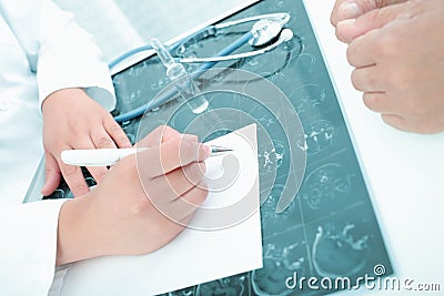 Doctor discusses with patient and prescribes treatment Stock Photo