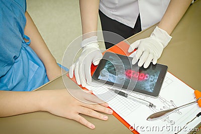 Doctor Discussing Records With Patient Using Digital Tablet PC Stock Photo