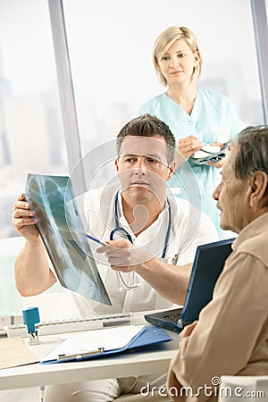 Doctor discussing x-ray image with patient Stock Photo