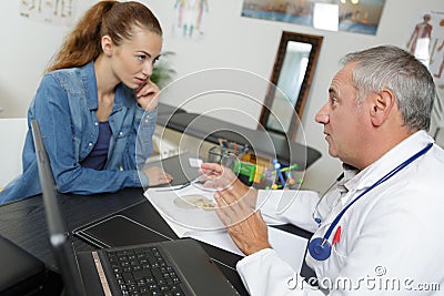 Doctor in discussion with young female patient Stock Photo