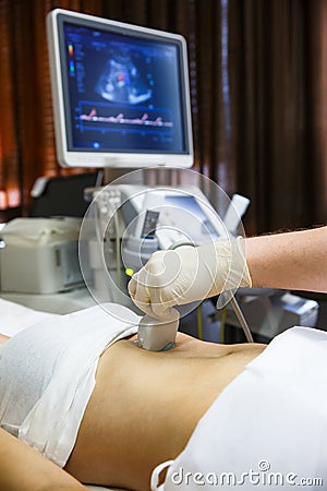 Doctor doing an ultrasound on a patient abdomen Stock Photo