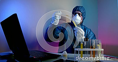 Doctor is dropping medicament in vial with coronavirus, performing experiment and looking for cure Stock Photo