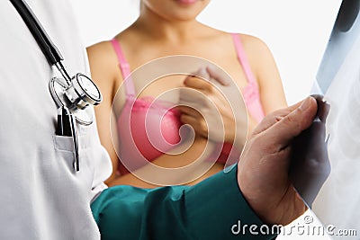 Doctor examine xray slide and nervous woman Stock Photo