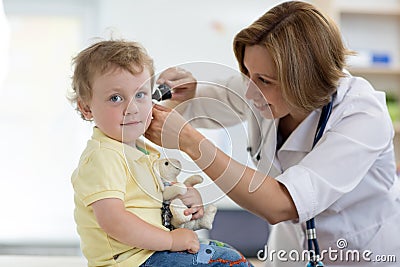 Doctor examines ear with otoscope in a pediatrician room. Medical equipment Stock Photo