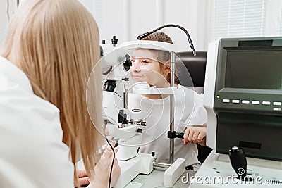 doctor examines girl with slit lamp. equipping ophthalmologist's office. Stock Photo