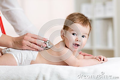 Doctor examining baby boy with stethoscope Stock Photo