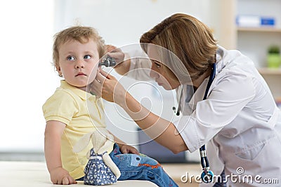 Doctor examining child`s ears in doctor`s office Stock Photo