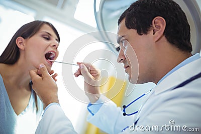 Doctor examining female patients mouth Stock Photo