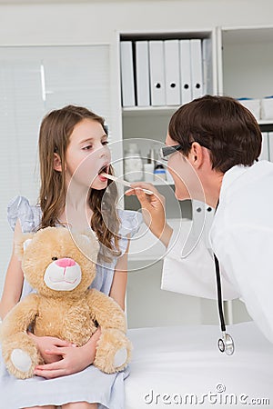 Doctor examining little girl mouth Stock Photo