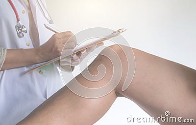 Doctor examining man leg at the hospital. Physiotherapist checking to the leg of patient. Stock Photo