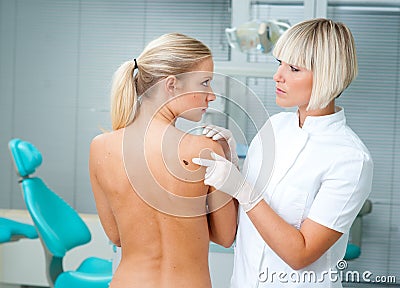 Doctor examining woman skin Stock Photo