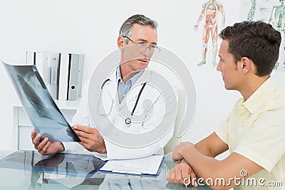 Doctor explaining lungs xray to patient in office Stock Photo