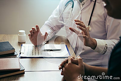 Doctor is explaining the treatment about the possible treatment of patients in the future Stock Photo