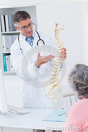 Doctor explaning anatomical spine to female patient Stock Photo