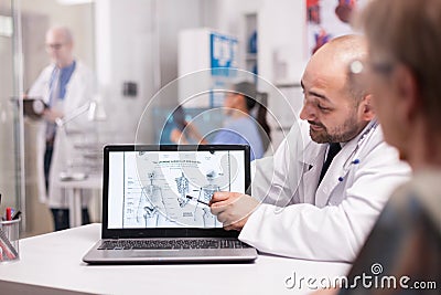 Doctor explaning back pain to senior patient Stock Photo