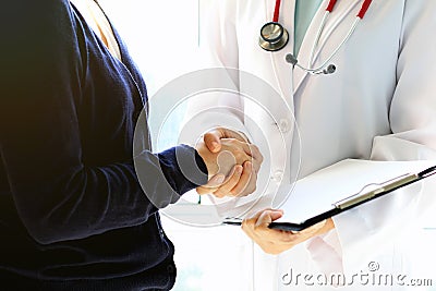 Doctor and female patient shaking hands, Healthcare and assistance concept. Stock Photo