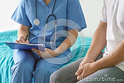 Doctor filling out a document for discharge from the hospital Stock Photo