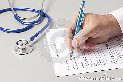 Doctor Filling Out Medical Form Stock Photo