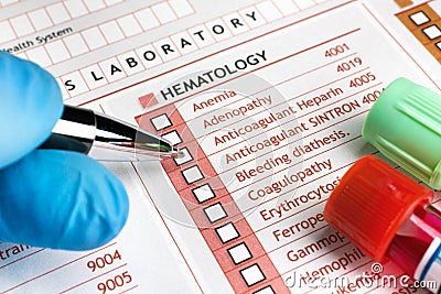 Doctor filling a request for clinical tests in medical consultation Stock Photo