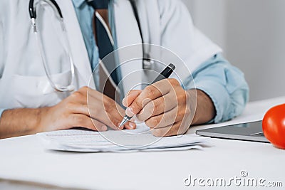 Doctor fills in data taking into account patient`s analyzes. Filling out patient medical history, personal data. Diagnosed Stock Photo