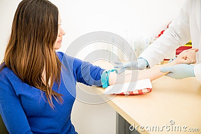 Doctor finding a vein on patient`s arm Stock Photo