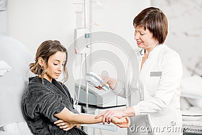 Doctor finding veins with vein scanner device Stock Photo