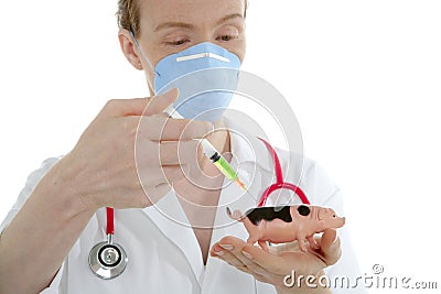 Doctor with flu vaccine syringe and toy pig Stock Photo