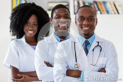 Doctor and general practitioner and nurse as african american medical team Stock Photo