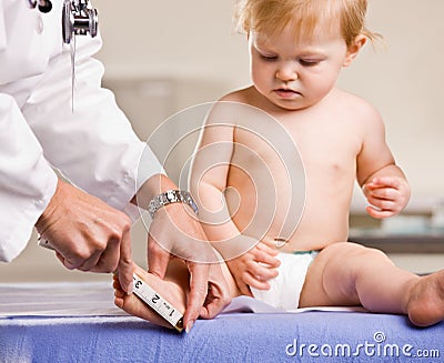 Doctor giving baby girl checkup in doctor office Stock Photo