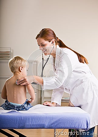 Doctor giving boy checkup in doctor office Stock Photo