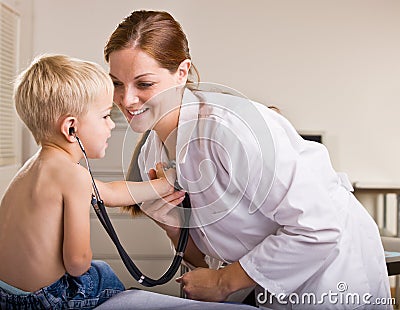 Doctor giving boy checkup in doctor office Stock Photo