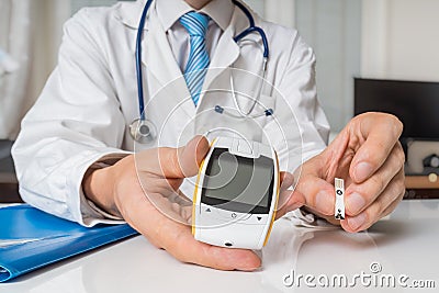 Doctor is giving glucometer to diabetic patient to measure blood sugar. Diabetes concept Stock Photo