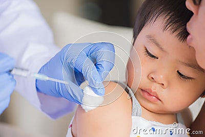 Doctor giving an injection vaccine to a girl. Stock Photo