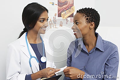 Doctor Giving Prescription To Patient Stock Photo