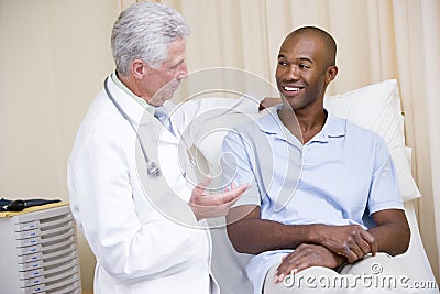 Doctor giving smiling man checkup Stock Photo