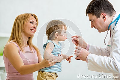 Doctor giving a spoon of syrup to little child Stock Photo