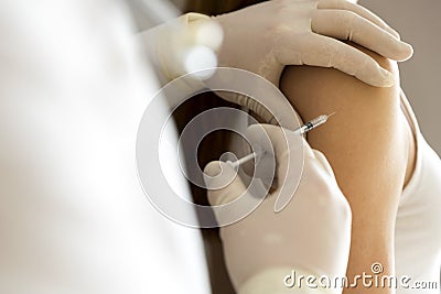 Doctor hand make patient insulin flu shot by syringe subcutaneous arm injection vaccination Stock Photo