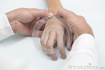 Doctor hand Physicist physical therapy treatment patient in the clinic. Orthopedic medical exam in doctor`s hospital office Partne Stock Photo