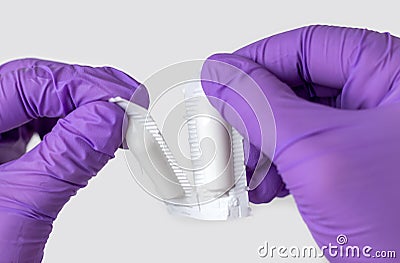 doctor hand in surgical gloves holding detach one anal or vaginal rectal suppositories anti fever virus constipation Stock Photo