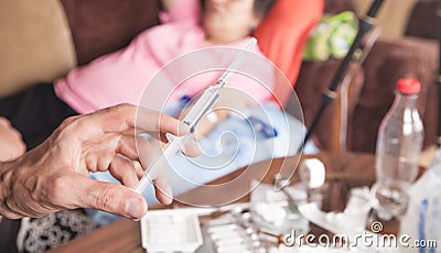 Doctor hand syringe. Making injection in patient Stock Photo