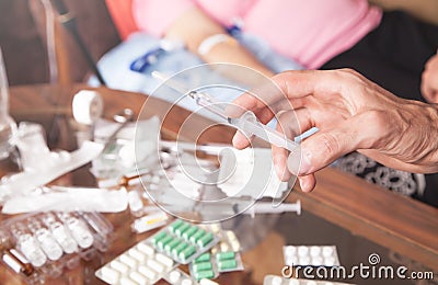 Doctor hand syringe. Making injection in patient Stock Photo