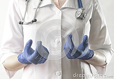 Doctor hands in blue gloves close up explaining and telling smth. Medical specialist, physician in uniform with Stock Photo