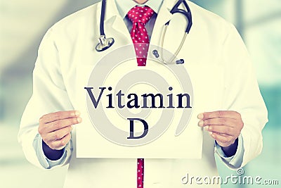 Doctor hands holding white card sign with vitamin D text message Stock Photo