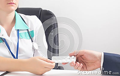 The doctor hands over a package of pills to a patient with psychosis and nervous breakdown. Concept of placebo effect, pills for Stock Photo